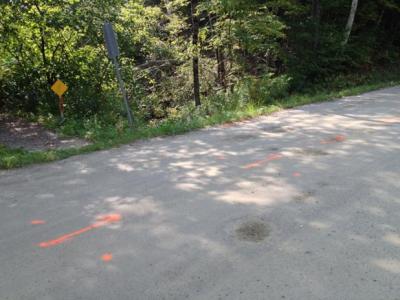 Spray paint markings to guide the road crew when they begin to replace the culvert. 